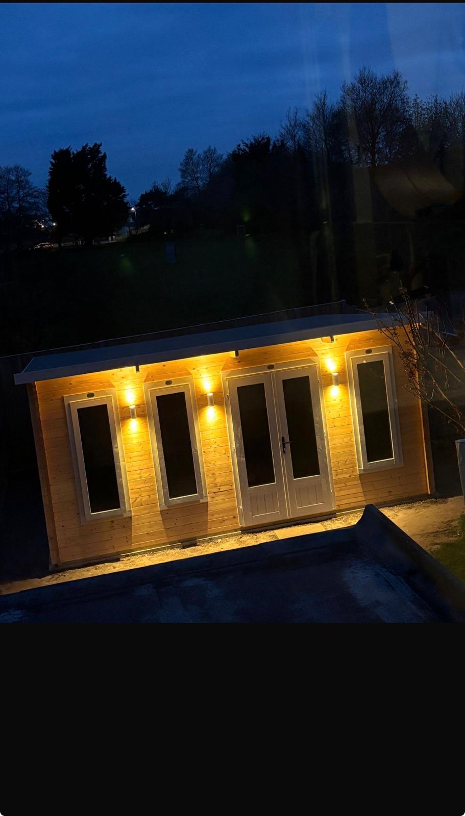 Garden room exterior wall lights at night